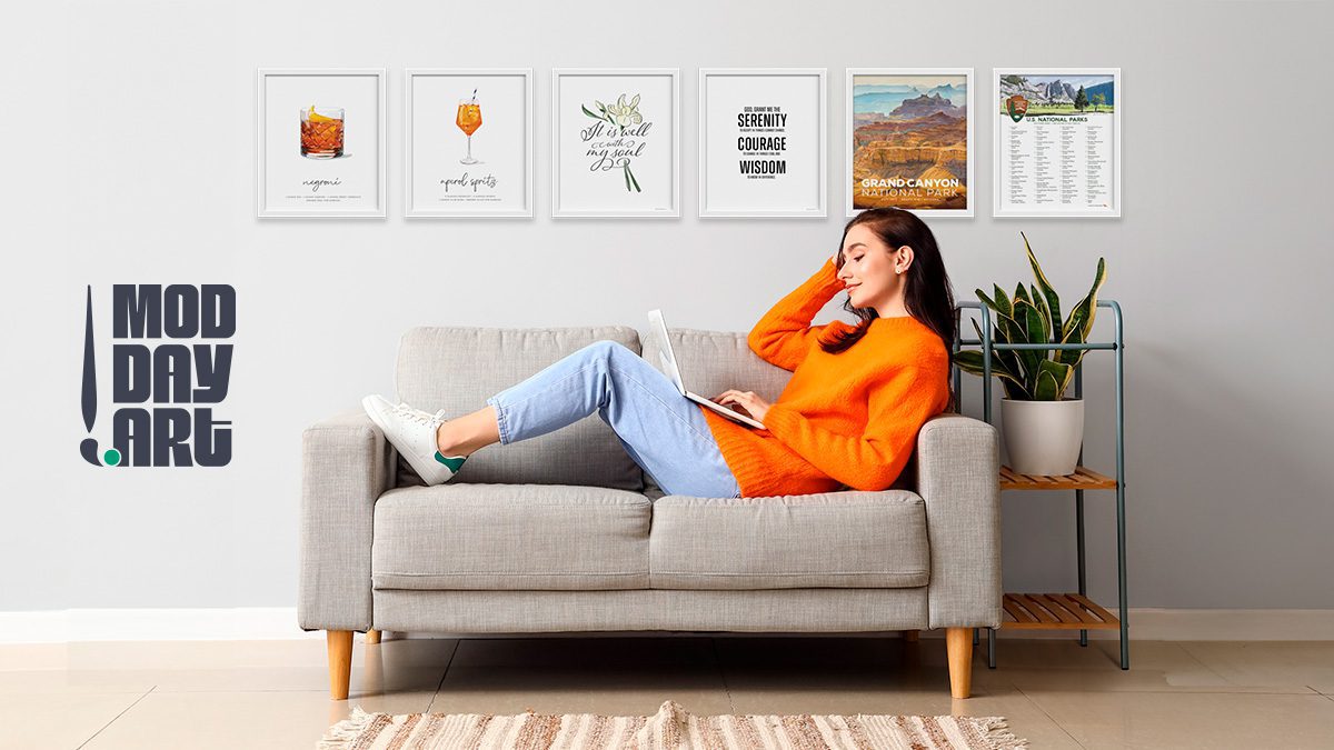 woman on couch with ModDayArt art prints on wall behind her